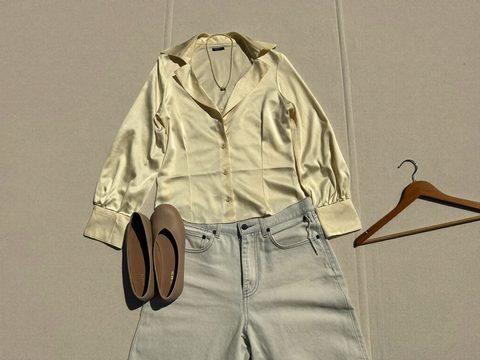 A flat-lay outfit with one space left for the piece that would complete it